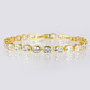 4 mm oval CZ tennis bracelet displayed in a circle on a reflective surface.