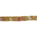 A close-up of a gold-toned beaded trim or ribbon featuring four decorative flower beads in purple, pale yellow, pink, and light blue, set against a plain white background.