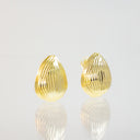A pair of gold teardrop-shaped stud earrings with a textured, ribbed surface, displayed on a reflective white surface against a light gray background.