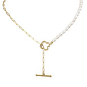 A delicate necklace featuring a strand of white freshwater pearls on one side and a gold paperclip chain on the other, with a gold four-leaf clover charm and a hanging gold toggle clasp, shown on a pure white background.