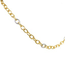 A close-up of a gold chain necklace with two small textured silver oval links, shown on a plain white background.