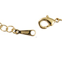 Close-up of a gold-tone chain bracelet showing a lobster clasp and a spring-ring clasp with '16KGP' engraved on one of the rings, on a plain white background.