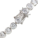 A close-up of a diamond tennis bracelet featuring round brilliant-cut diamonds set in a silver-colored metal, with the clasp mechanism visible.