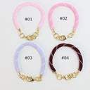 Four braided cord bracelets arranged in a 2x2 grid on a white background, each labeled with a number from #01 to #04. The top row features light pink bracelets, and the bottom row features light lavender and dark burgundy bracelets.