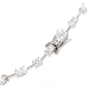 A close-up of a diamond tennis bracelet on a plain white background, showing rectangular and marquise-cut diamonds set in silver-colored metal.