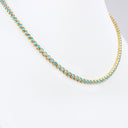 A gold tennis necklace with small round turquoise-blue stones, displayed on a white mannequin bust against a white background.