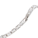 A close-up of a silver tennis bracelet featuring rectangular clear crystals in a row, set in a polished silver-tone metal, shown against a plain white background.
