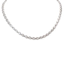 A silver-toned diamond necklace featuring a curved row of teardrop-shaped diamonds in prong settings, displayed against a solid white background.