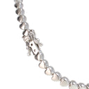 A close-up of a silver heart-link chain necklace, showing the polished clasp and several heart-shaped links on a plain white background.