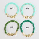 Four braided cord bracelets arranged in a 2x2 grid on a white background, labeled #05, #06, #07, and #08. Each bracelet has a gold-tone clasp and ring hardware.