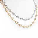A double-strand necklace featuring oval-cut clear gemstones in yellow gold and silver-toned settings, displayed on a clean white background.