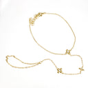A delicate yellow gold chain necklace with three small, stylized flower or clover-like charms, displayed on a clean white background.