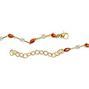 Gold chain bracelet featuring marquise-cut amber garnet stones and small clear cubic zirconia accents, shown on a plain white background.