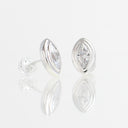 A pair of silver stud earrings with marquise-cut clear gemstones, shown on a reflective white surface against a light gray background.
