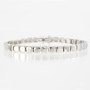 A silver tennis bracelet with polished square-shaped links, displayed on a clean white reflective surface.