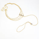 A gold-toned multi-strand chain necklace with three small round clear rhinestone accents, displayed on a clean white background.