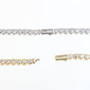 A tennis bracelet shown in two metal finishes: a silver-tone version with clear stones across the top and a gold-tone version shown below, both displayed on a plain white background.
