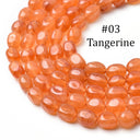 A close-up of peachy orange translucent oval beads, labeled '#03 Tangerine' on a white background.