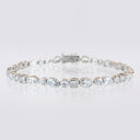 Mixed‑Shape Bezel CZ Bracelet displayed in a circle on a reflective surface.