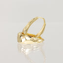 A polished gold hoop earring with a textured, organic wavy surface, displayed on a reflective light gray surface.