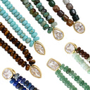 Six beaded necklaces arranged diagonally on a white background, each featuring gold-tone metal bezel settings with clear gemstones and multi-strand beads in different colors including turquoise, brown, green, blue, and gray.