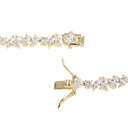 A close-up studio shot of a yellow gold tennis bracelet showing the clasp mechanism and a section of the chain set with clear stones on a white background.