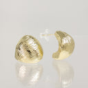 A pair of gold crescent-shaped stud earrings with a textured, ribbed surface, displayed on a reflective light gray surface.