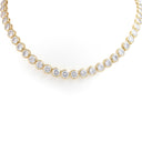 A yellow gold tennis necklace featuring round-cut clear gemstones in bezel settings, displayed against a clean white background.