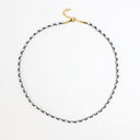 A delicate braided chain necklace with a gold clasp and extender chain, displayed on a clean white background.