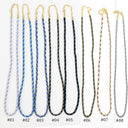 Eight braided cord necklaces with gold-tone chain links and clasp are displayed side by side on a white background, labeled #01 through #08. The cords come in light blue with dark blue stripes, dark blue with yellow stripes, black with yellow stripes, black with blue stripes, black with yellow stripes, olive green with gold stripes, gold with brown stripes, and light gray with dark gray stripes.