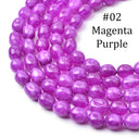 A close-up of glossy, faceted oval beads in a vibrant magenta-purple color, arranged in a curved line on a white background with the text '#02 Magenta Purple' printed in black.