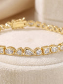 Mixed‑Shape Bezel CZ Bracelet displayed in a circle on a cream velvet surface.