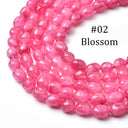 A close-up of multiple strands of faceted pink gemstone beads, labeled '#02 Blossom' on a white background.