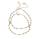 Two delicate beaded necklaces in a two-tone gold and silver finish, displayed on a clean white background. One necklace features polished gold and silver beads, while the other has clear crystal-like round beads.