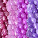 Close-up of strands of polished oval beads in pink, purple, and violet tones, arranged vertically with glossy highlights.