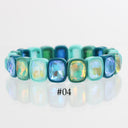 A stretch bracelet made of rectangular cabochon gemstones in shades of blue, teal, and green with an iridescent finish, displayed on a reflective white surface with the text '#04' below.