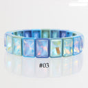 A bracelet made of rectangular iridescent rhinestones in shades of light blue, aqua, and lavender, displayed on a reflective white surface with the text '#03' below it.